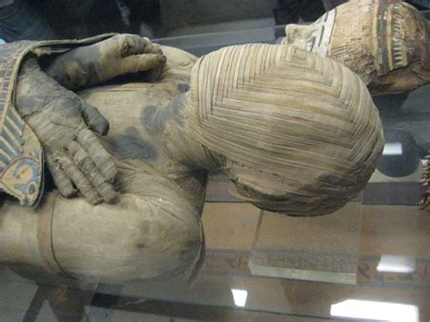 Ancient Egyptian mummy at the Louvre has a face covered by an unusual interwoven square pattern ...