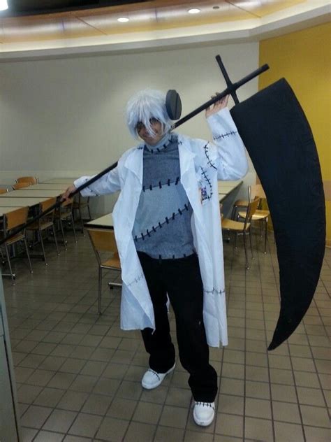 a man with white hair is holding an umbrella and posing for the camera in a classroom