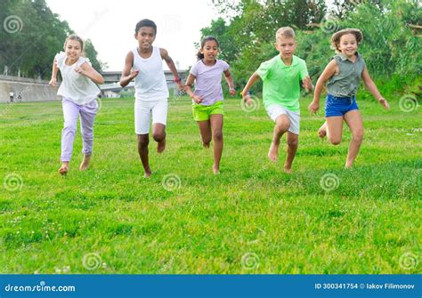 Barefoot Kids Running on Green Grass Stock Photo - Image of field, girl: 300341754