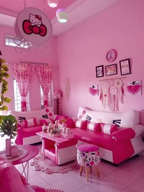 a pink and white living room with hello kitty decorations on the walls, couches and tables