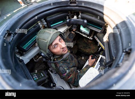 19 April 2018, Germany, Munster: A Bundeswehr commander sits inside a tank of the model Leopard ...