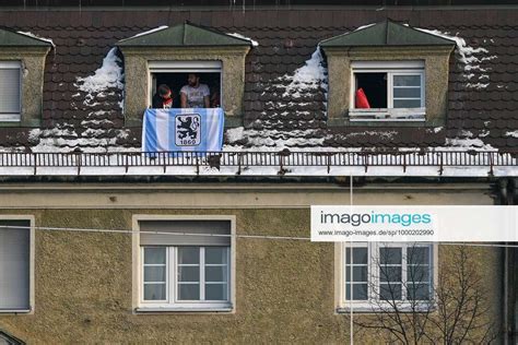 TSV 1860 Munich fans watch the match from the windows opposite the stadium, 09 01 2021, Munich