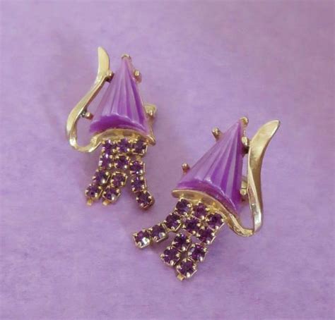 Purple earrings. These are very unusual mid century modern clip-on earrings. Are they comet ...