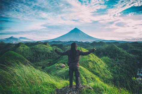 Person Standing on Top Of Hill · Free Stock Photo