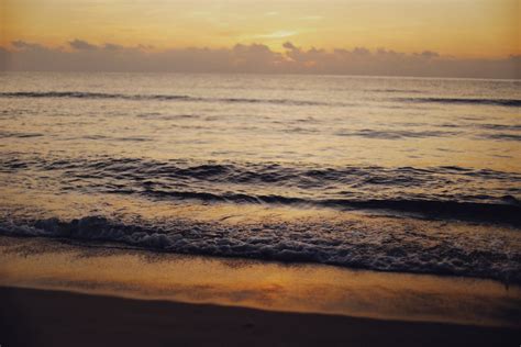 Photo of Water on a Beach During Sunset · Free Stock Photo