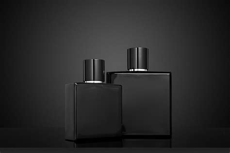 Premium Photo | Two black perfume bottles on a black background mockup ...