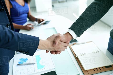 Businessmen shaking hands after successful deal - Stock Photo - Dissolve