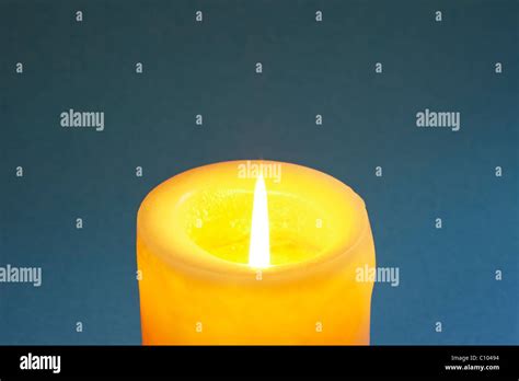 Candle with blue background Stock Photo - Alamy