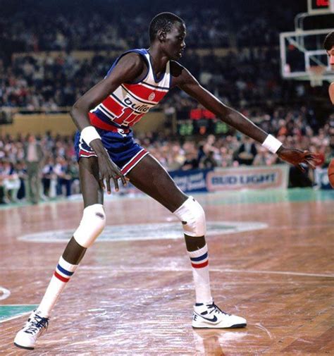 Manute Bol, a 7’7″ Dinka tribesman from the Sudan who was selected by ...