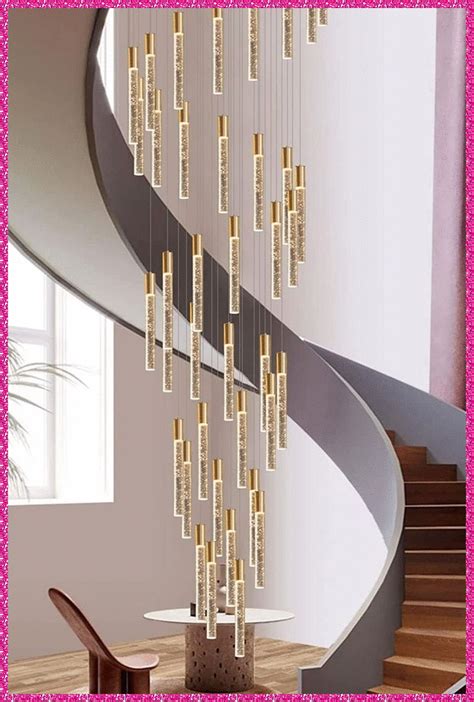 a spiral staircase with chandelier hanging from it