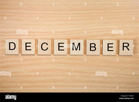 The word December, spelt out using wooden tiles on a wood effect background Stock Photo - Alamy