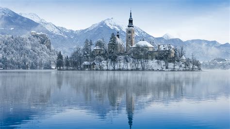 View of church on island on Lake Bled in winter, Slovenia | Windows ...