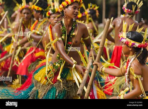 Yapese girls in traditional clothing dancing with bamboo pole at Yap Day Festival, Yap Island ...