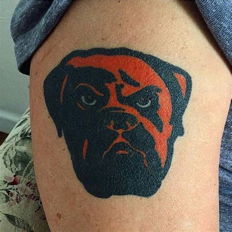 a man with a bulldog tattoo on his arm