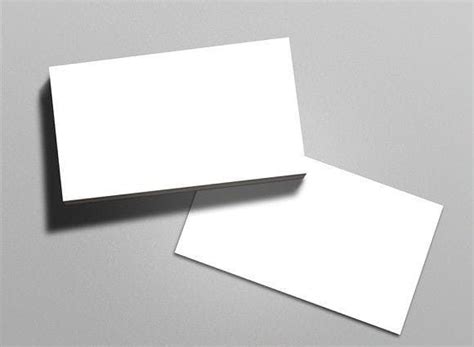 two blank business cards sitting on top of each other