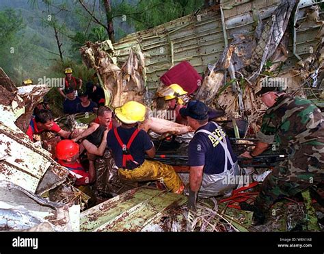 U.S. Navy, U.S. Air Force, U.S. Coast Guard and civilian rescuers remove a survivor from the ...