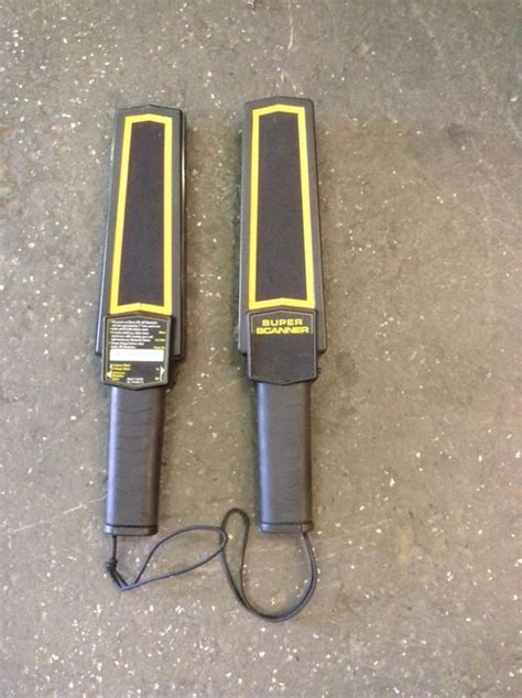 two black and yellow electric tools laying on the ground next to each ...