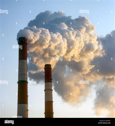 Air pollution by smoke coming out of two factory chimneys Stock Photo - Alamy