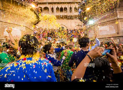 Crowd throwing flower petals during the Flower Holi Festival, Vrindavan ...