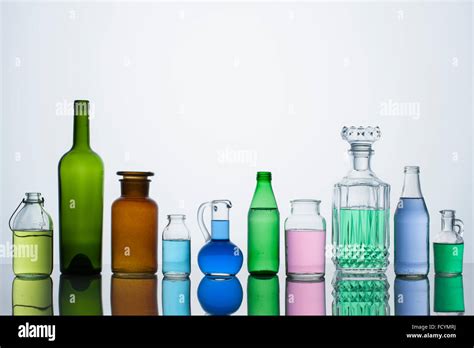 Different types of glass bottles arranged in a row Stock Photo ...
