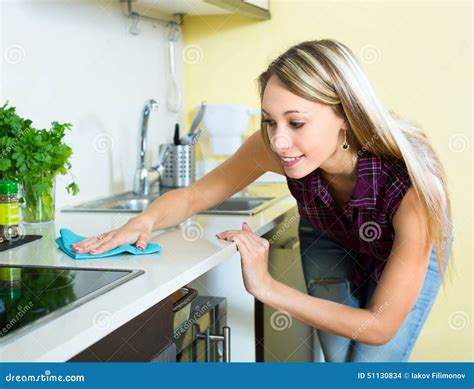 Woman cleaning kitchen stock photo. Image of atomizer - 51130834