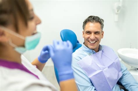 Premium Photo | Dentist and patient interacting and smiling.