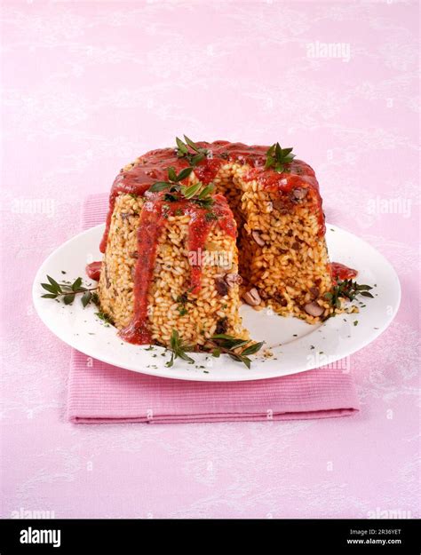 Italian rice timbale with tomato sauce Stock Photo - Alamy