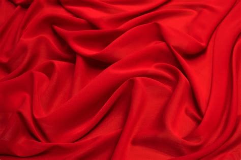 Premium Photo | Red silk fabric cloth waves texture.