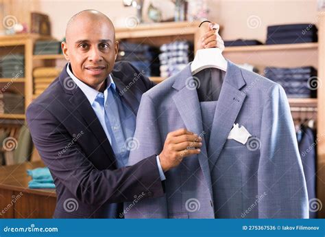 Friendly Salesman Offering Suit in Menswear Boutique Stock Photo ...