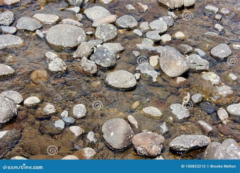 Rocks in a river bed stock photo. Image of pattern, river - 100853210