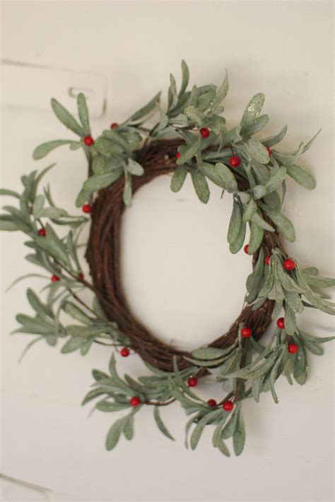 This mistletoe wreath is a great piece to bring on the holidays. Hang it on your front door for ...