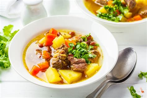 Premium Photo | Traditional eintopf soup with meat, beans and vegetables in a white plate, white ...