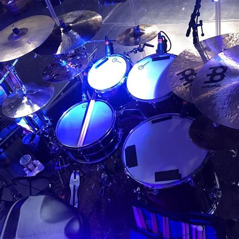 a drum set up on stage with blue lights