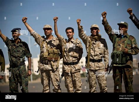 Houthi Shiite Yemenis wearing army uniforms chant slogans during a ...