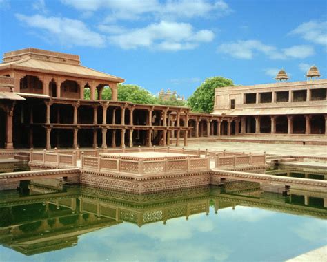 an old building with water in the middle