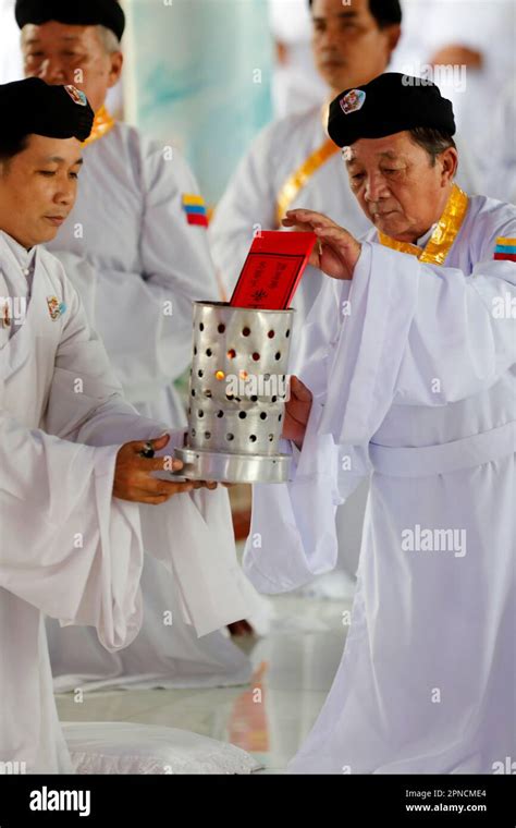 Cao Dai temple. Caodaist worshippers at ceremony. Meditating followers of the Cao Dai religion ...