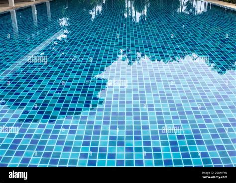 Blue and light blue swimming pool floor tiles alternately mix and match no mess Stock Photo - Alamy