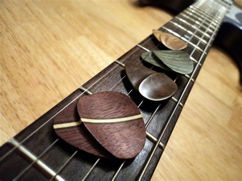 Buy Hand Crafted Wooden Guitar Picks With Hand-Shaped Thumb Grip, made to order from Sandman ...