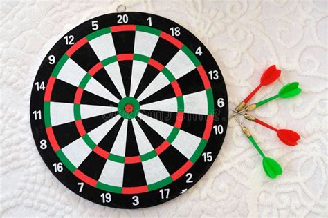 Dartboard and Dart Arrows Standing on Black Ground.dart Arrow Stuck and ...