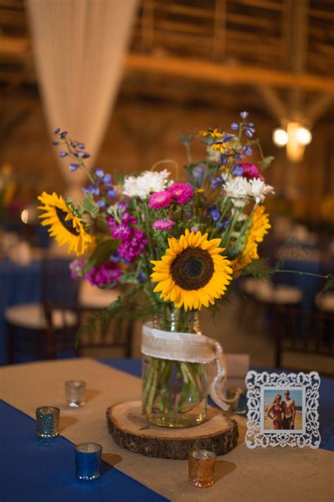 Sunflower and Wildflower Centerpiece on Wooden Slab