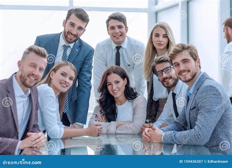 Corporate Group Of Employees Sitting At The Office Desk Stock Image ...