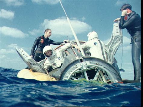 Navy divers assist Gemini 6 crew to open hatches after landing