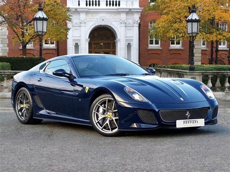 a blue sports car parked in front of a building