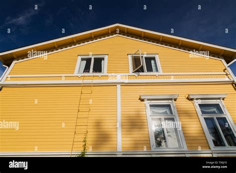 White windows on exterior side wall of a yellow two story house, Porvoo ...