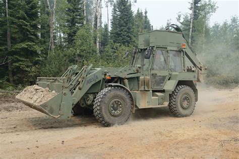 A Combat Engineer operates a MPEV to ensure the road is accessible to all emergency vehicle ...