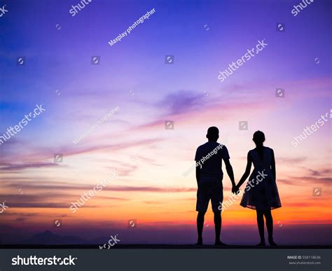 Couple Silhouette Holding Hands Watching Sunset Stock Photo 558118636 ...