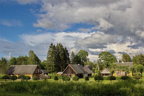 Estonian Countryside - Green Field, Cloudy Sky And Traditional Rural House Stock Photo - Image ...