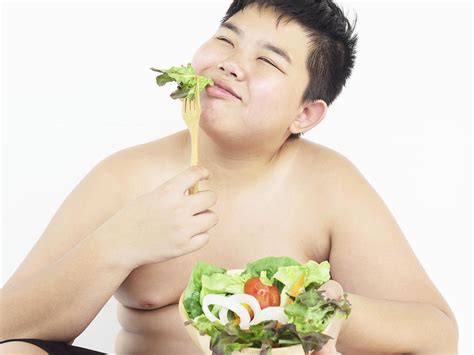 A fat boy is happily eating vegetable salad 9303882 Stock Photo at Vecteezy