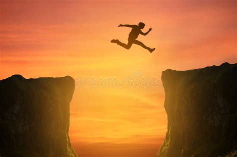 Man Jumping Over the Cliff, Silhouette Stock Photo - Image of nature, freedom: 96003244