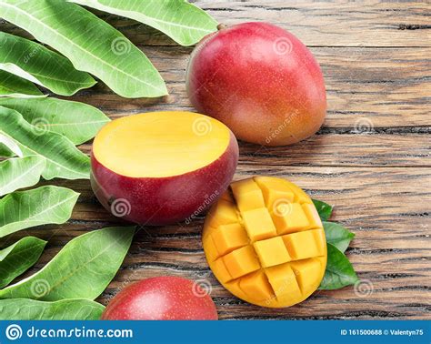 Mango Fruits and Mango Slices on the Old Wooden Table Stock Photo - Image of leaf, tropical ...